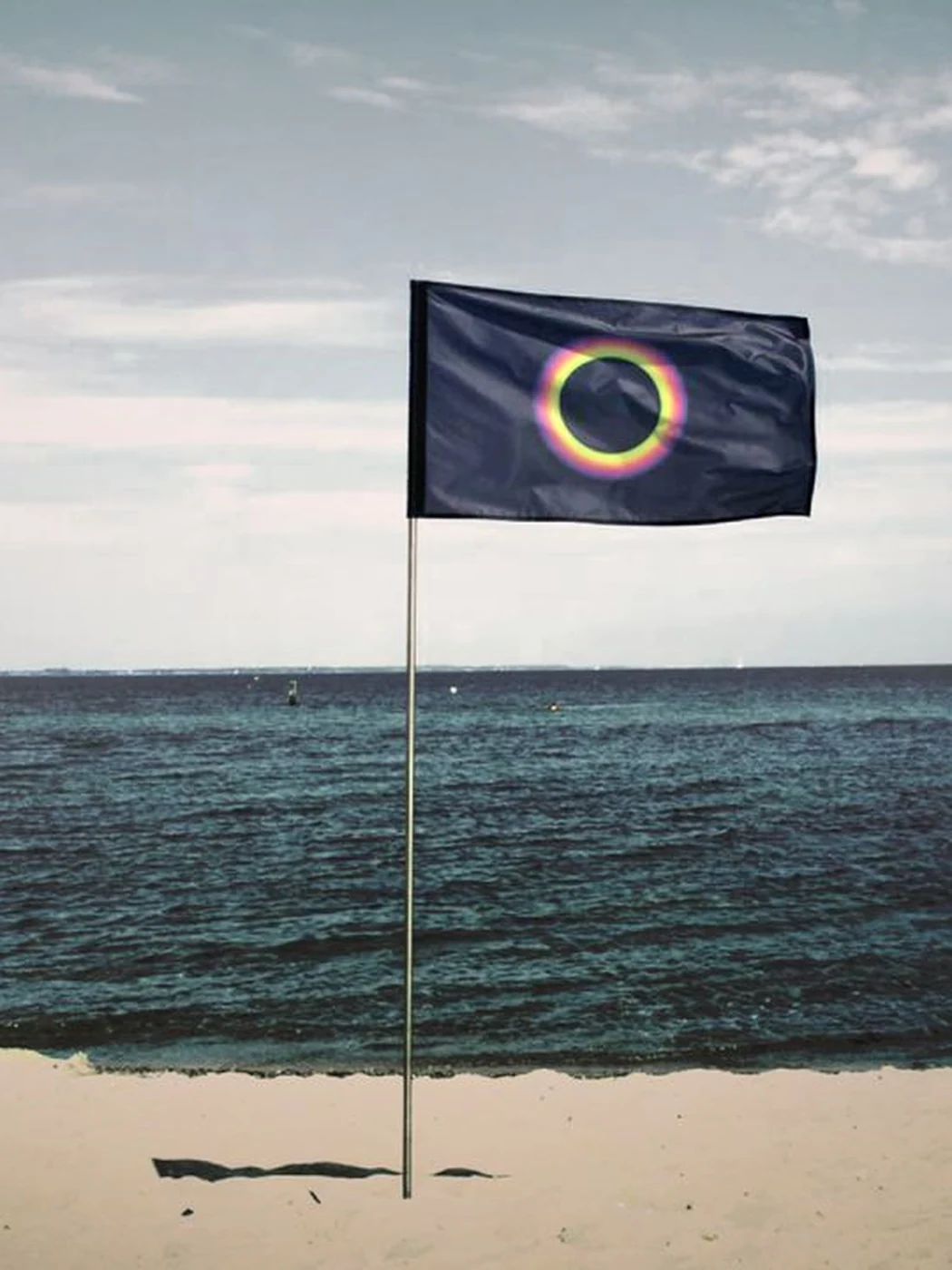 The Sun Warning Flag flying on an empty beach