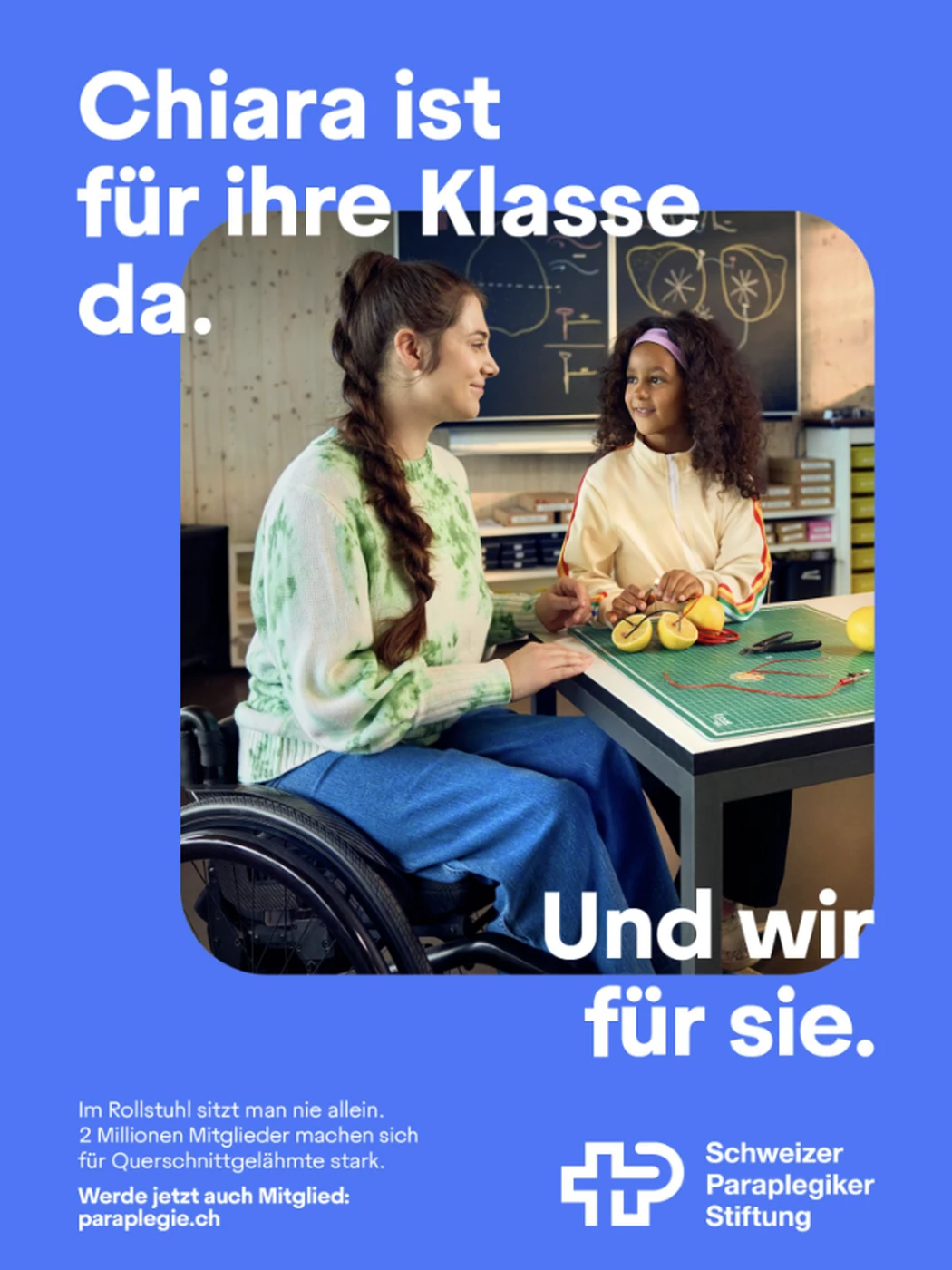 Poster: a teacher in a wheelchair with a pupil in a classroom